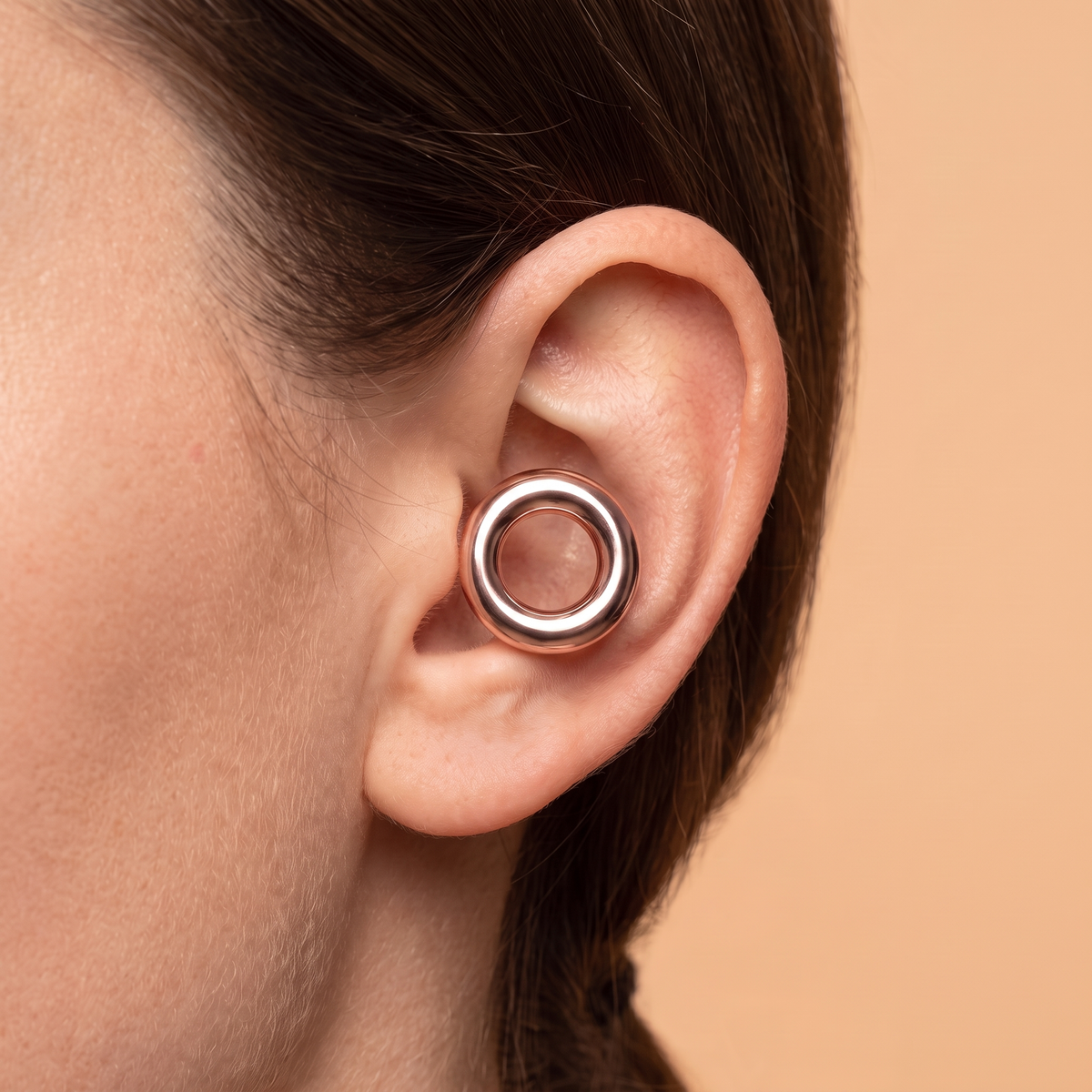 Metal Edition Earplugs in Rose Gold, worn in ear